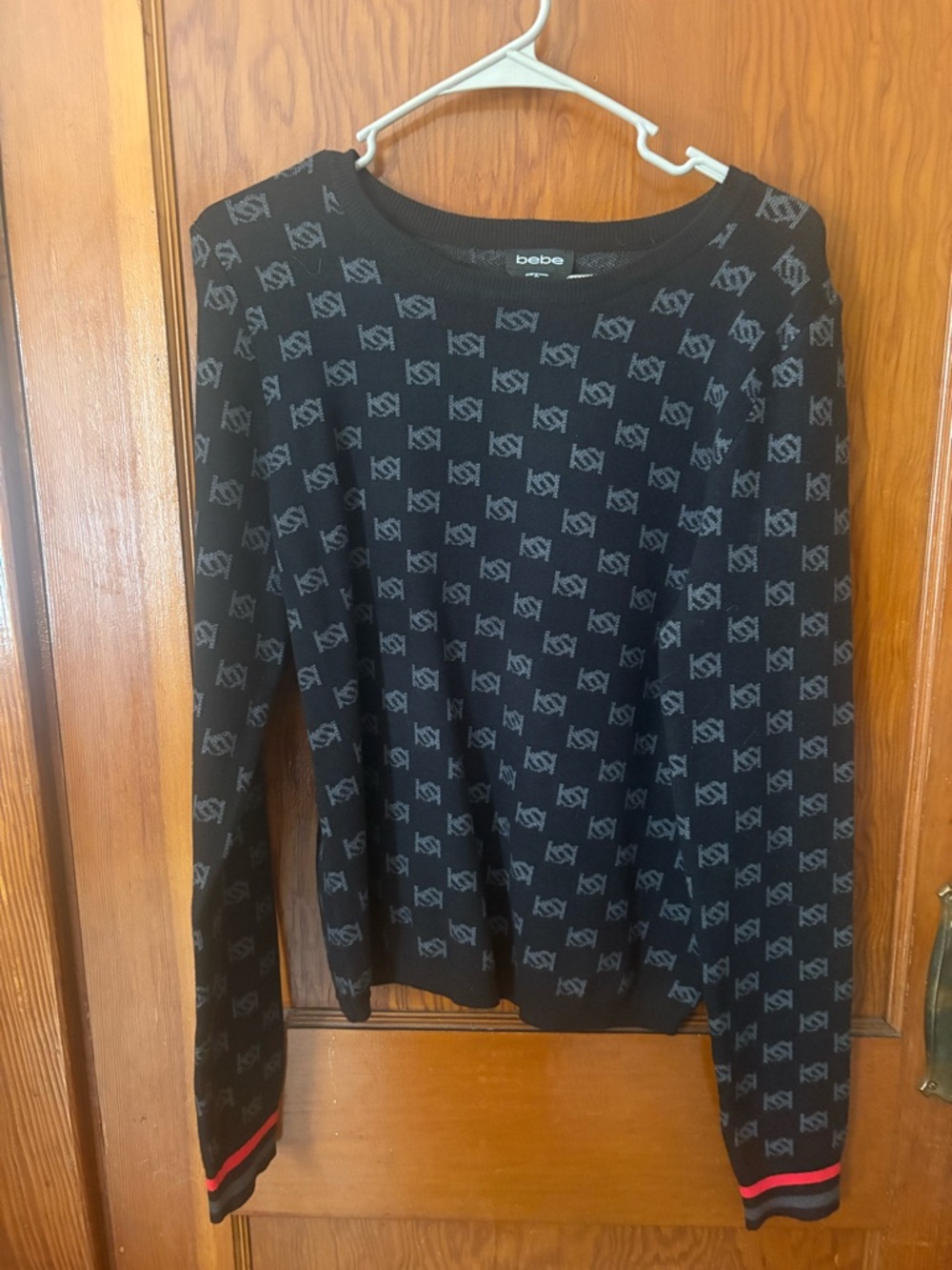 bebe Black Sweater with Gray Logo Jacquard and Red Cuff Accents